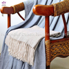 Herringbone pattern blanket with tassels.