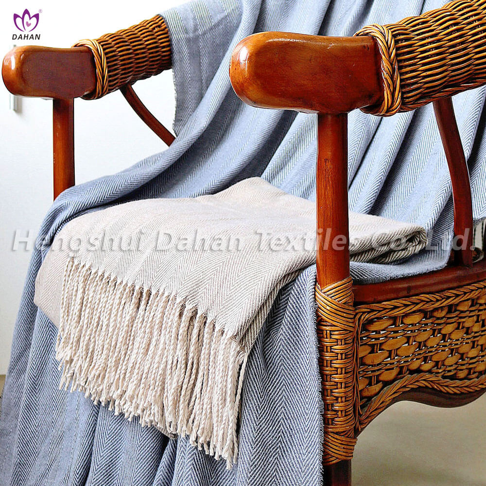 Herringbone pattern blanket with tassels.