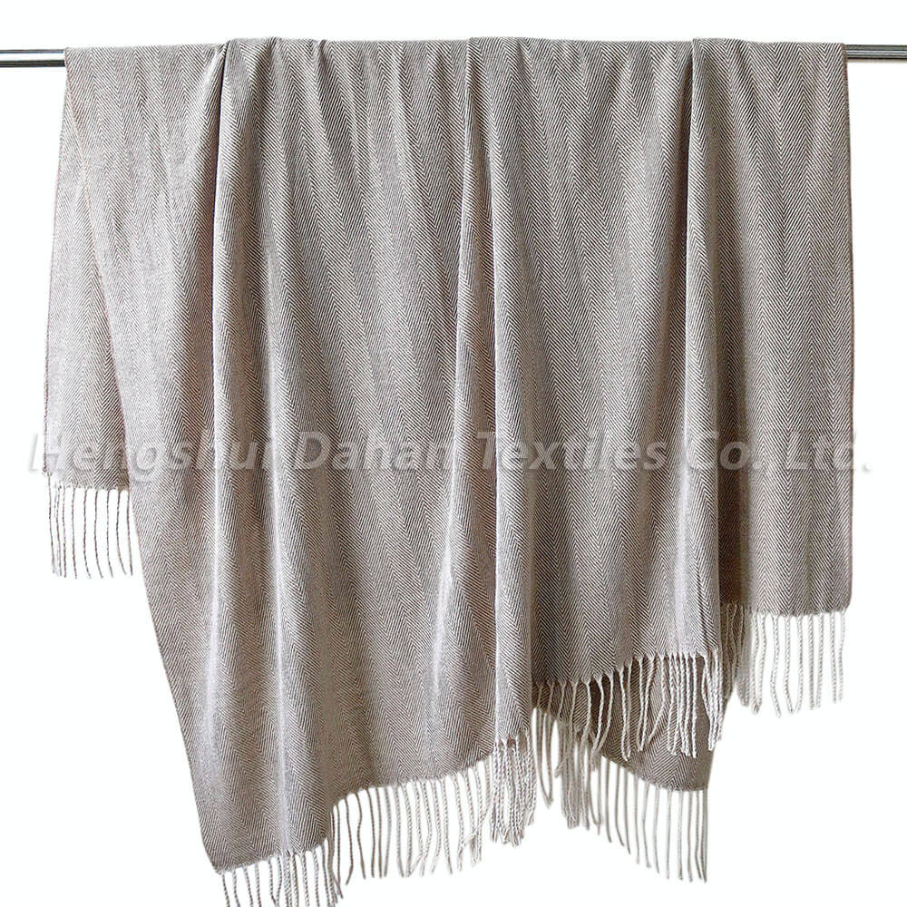 Herringbone pattern blanket with tassels.