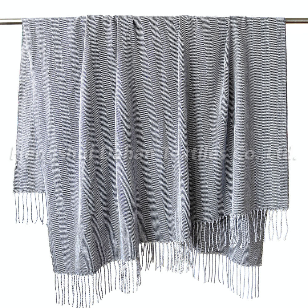 Herringbone pattern blanket with tassels.