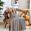 Herringbone pattern blanket with tassels.